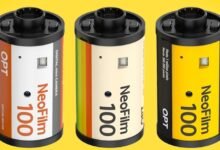 Three NeoFilm 100 digital mini cameras resembling film canisters.