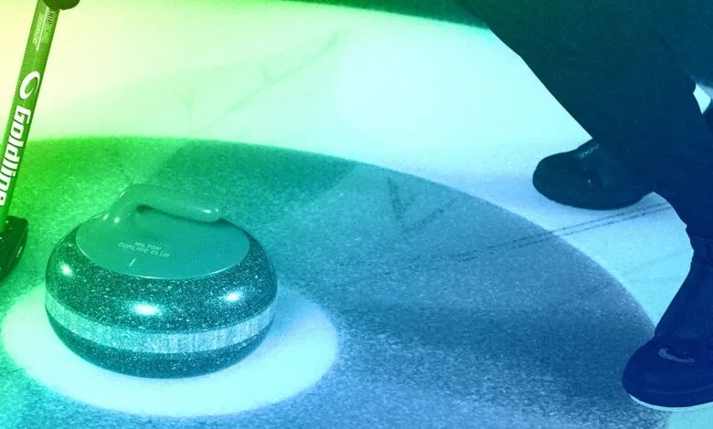 Curling stone and broom on ice with a person wearing curling shoes.