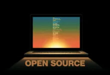 Laptop displaying code with 'Open Source' text below on black background.