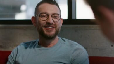 Peter Steinberger smiles during a conversation, wearing glasses.