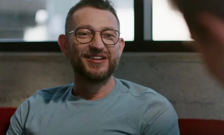 Peter Steinberger smiles during a conversation, wearing glasses.