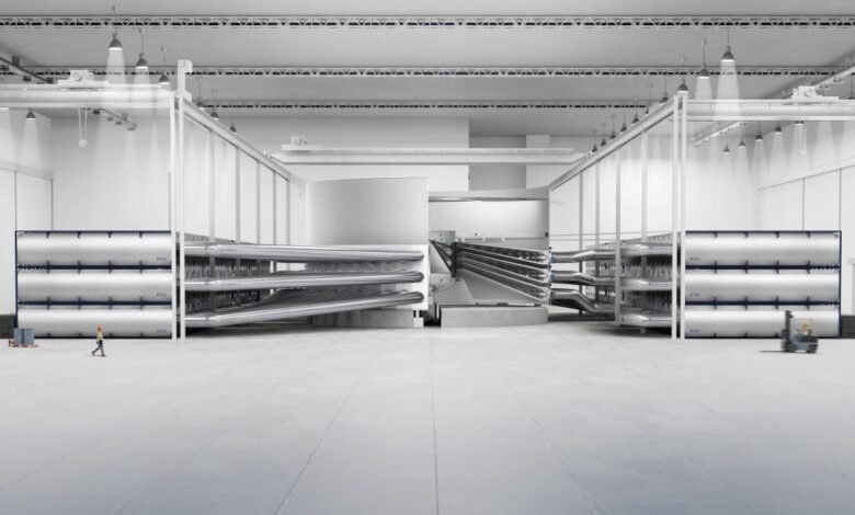 Fusion reactor core inside a large, bright industrial facility.