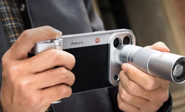 Person holds iPhone with RetroVa telephoto lens attachment.