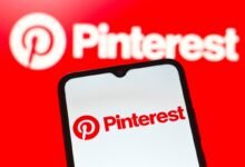Pinterest logo displayed on a smartphone screen against a red background.