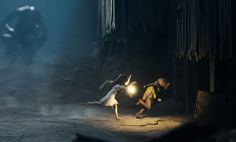 Two figures flee through a dark, misty environment, one holding a lantern.