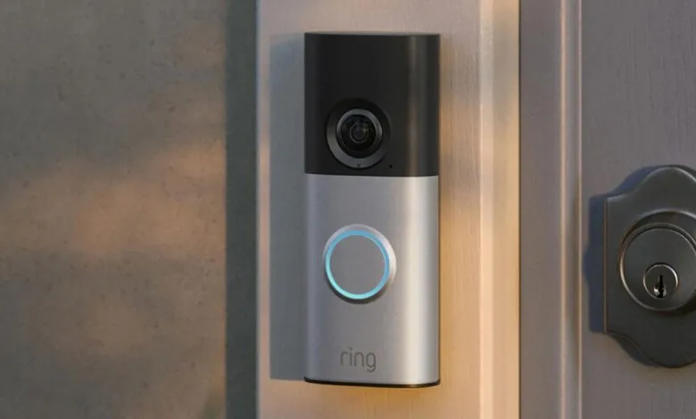 Ring video doorbell mounted on a doorframe with a lock nearby.