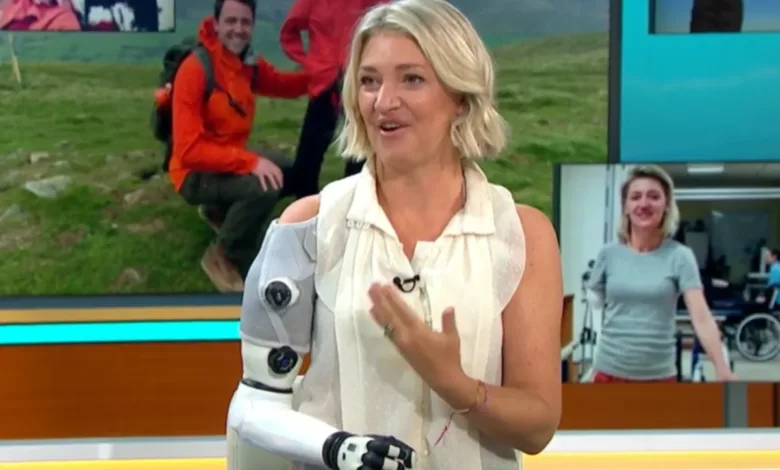 Woman with robotic arm on TV show, smiling and gesturing.