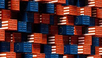 Stacked shipping containers with US and EU flag designs.