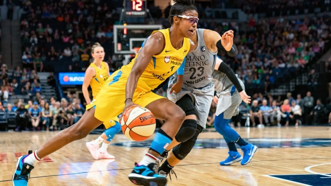 WNBA player Candace Parker dribbles the ball during a game.