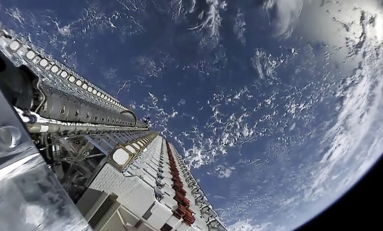 View of Starlink satellites in orbit above Earth, showing the planet's curvature and cloud cover.