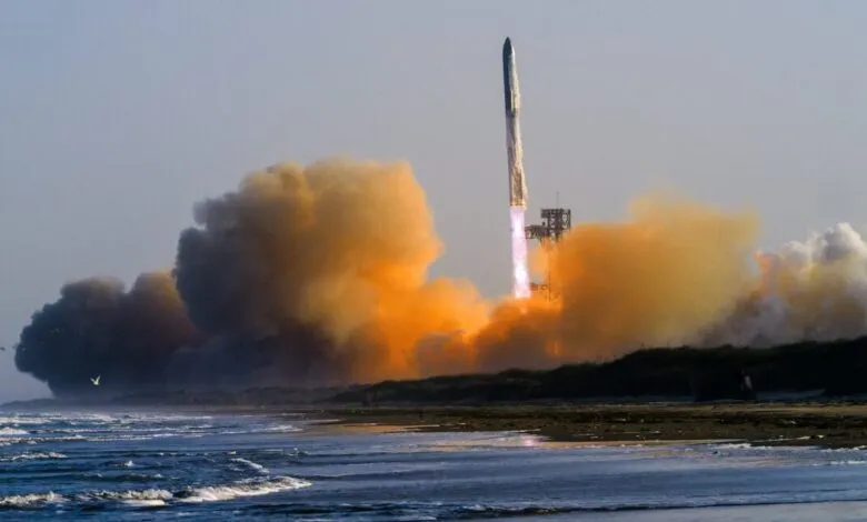 Rocket launches from beach, surrounded by orange and white smoke.