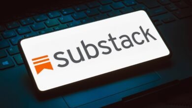 Substack logo displayed on a smartphone screen resting on a laptop keyboard.