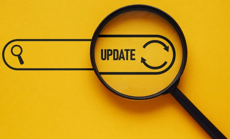 Magnifying glass focuses on the word 'UPDATE' with refresh arrows.