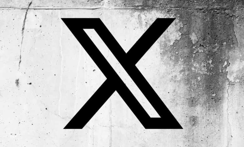 Black X logo on a textured concrete wall background.