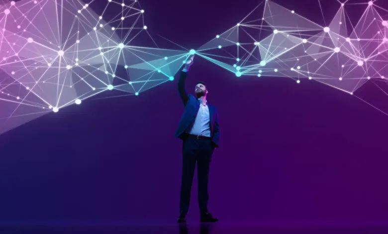 Man in suit interacts with glowing network of connected nodes.