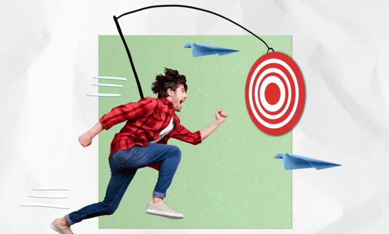 Man running towards target on a string, paper airplanes fly by.