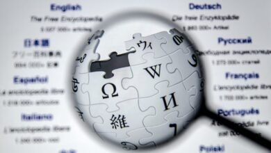 Wikipedia logo, a puzzle globe, is magnified against a list of languages.