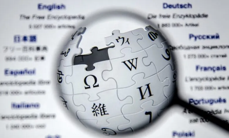 Wikipedia logo, a puzzle globe, is magnified against a list of languages.