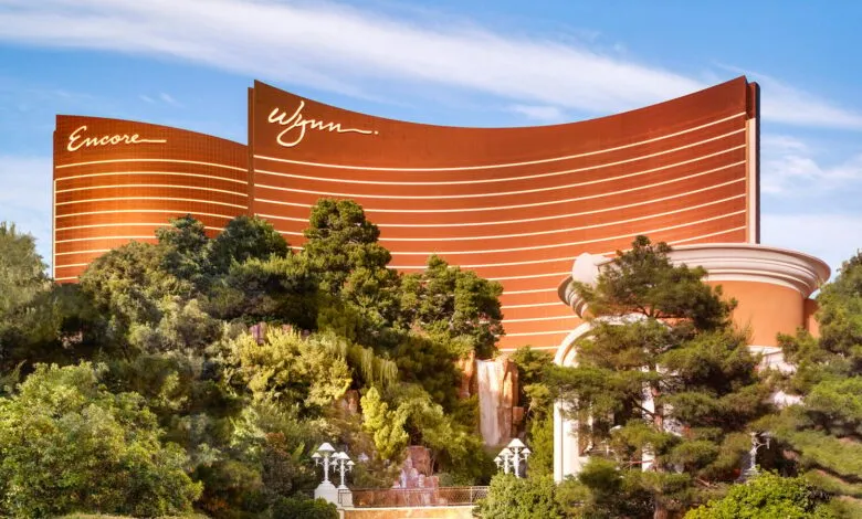 Wynn and Encore hotels in Las Vegas with lush greenery and a waterfall.