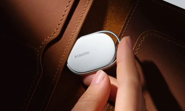 Xiaomi tracker being placed in a brown leather wallet.