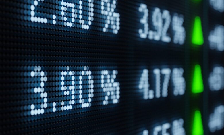 Close-up of a stock market ticker displaying rising interest rates.