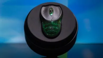 Razer mouse in a black circular case, close-up shot.