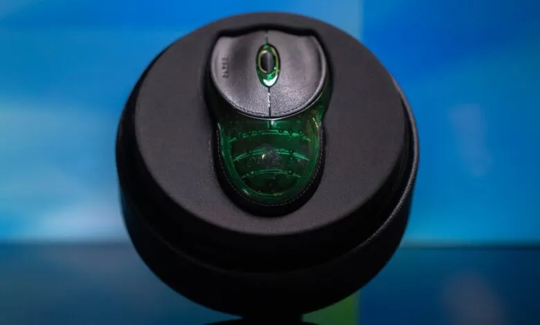 Razer mouse in a black circular case, close-up shot.
