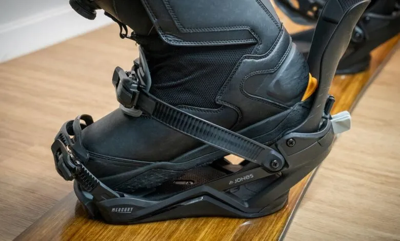 Close-up of a black snowboard boot secured in a Jones Mercury binding.