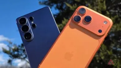 Close-up of blue and orange smartphones showing camera lens details.