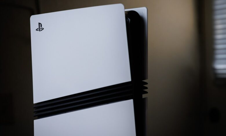 PlayStation 5 console standing vertically, white panels.