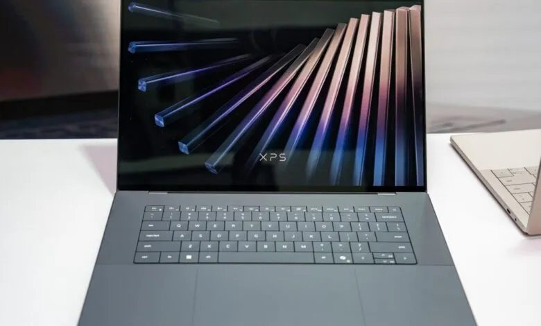 Dell XPS laptop with sleek design and vibrant display showing abstract art.