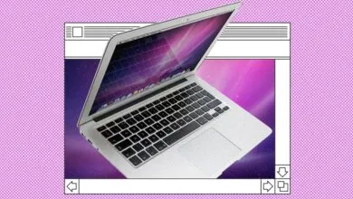 Silver MacBook Air laptop with a purple galaxy background and retro frame.