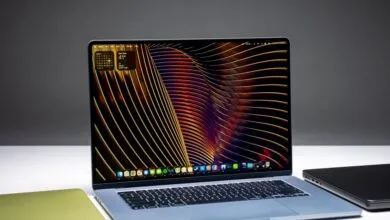 Open MacBook Air 15-inch laptop with a colorful abstract wallpaper display.