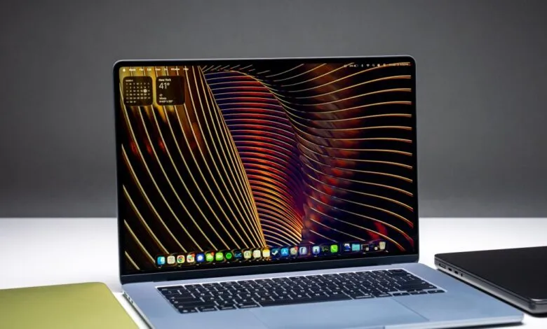 Open MacBook Air 15-inch laptop with a colorful abstract wallpaper display.