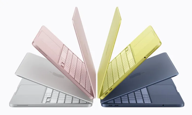 Four colorful Apple MacBook Air laptops in silver, pink, yellow, and blue on a white background.