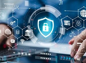 Digital tablet displaying cybersecurity shield with various tech icons.