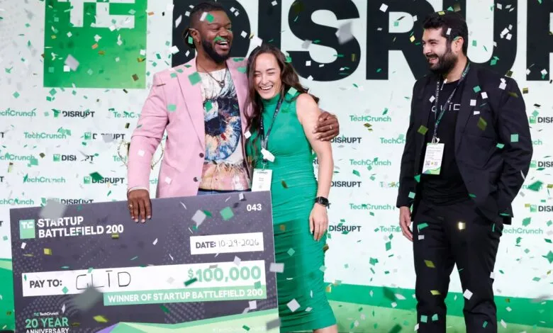Three people celebrate winning TechCrunch Startup Battlefield, confetti falling.