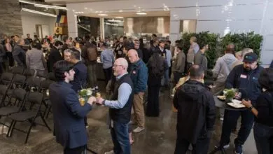 Networking event with people mingling in a modern, open space.