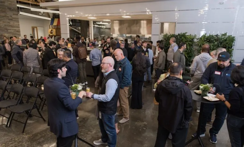 Networking event with people mingling in a modern, open space.