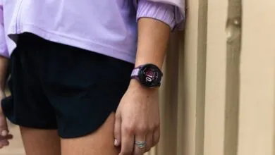 Close-up of a woman's wrist wearing a purple Garmin smartwatch.
