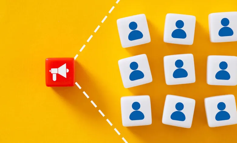 Red dice with megaphone icon targeting audience of blue people icons.