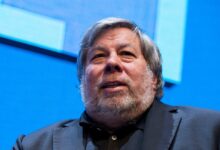 Steve Wozniak looks up with a slight smile against a blue background.