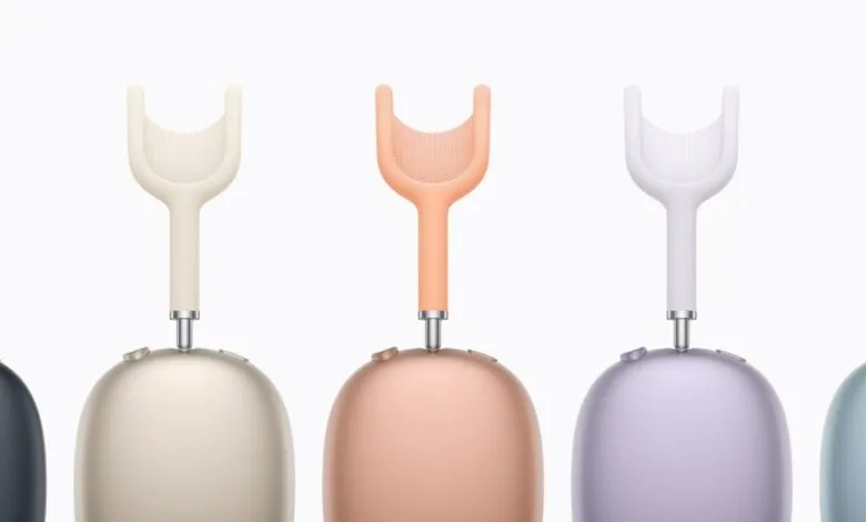 Five Apple AirPods Max headphones in different colors: space gray, silver, pink, green, and blue.