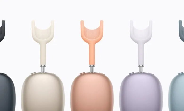 Five Apple AirPods Max headphones in different colors: black, white, orange, purple, and blue.