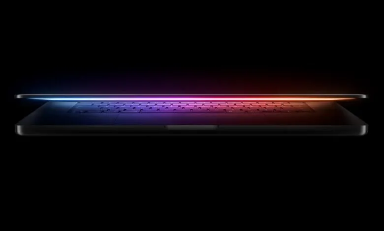 Sleek laptop with a glowing, colorful keyboard on a black background.