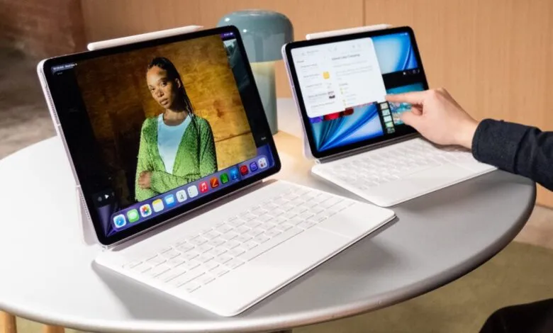 Two new iPad Airs with M4 chip on a table, one showing a video.