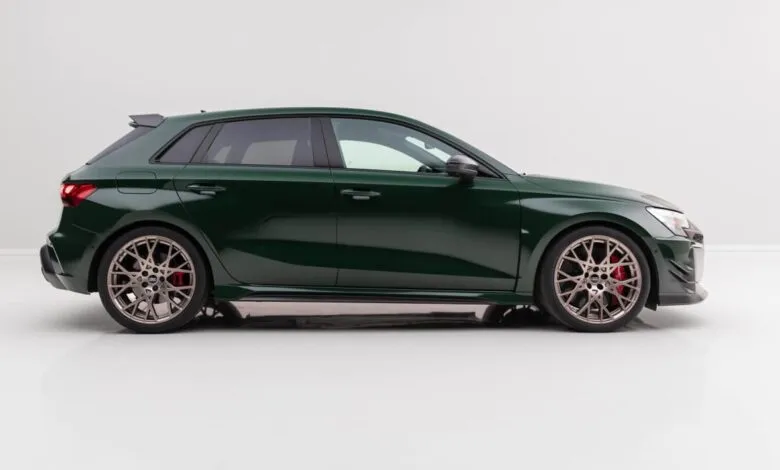Side view of a dark green Audi RS3 Competition with custom wheels.