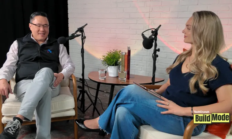Podcast recording with two people in chairs and microphones.