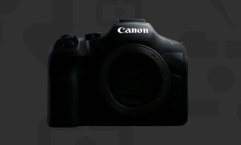 Close-up of a black Canon camera body against a dark gray patterned background.