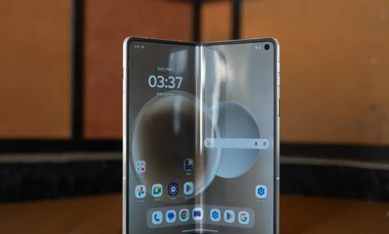 Foldable smartphone displaying its home screen with time 3:37 and app icons.